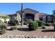 Desert landscaping enhances the property's curb appeal with mature cacti and verdant shrubbery at 6240 E Ironwood Dr, Scottsdale, AZ 85266