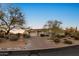 Inviting home with a brick driveway, three-car garage, and desert landscaping at 6240 E Ironwood Dr, Scottsdale, AZ 85266