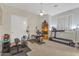 Home gym with a treadmill, weight bench, and a window at 6240 E Ironwood Dr, Scottsdale, AZ 85266
