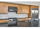 The kitchen includes a stainless steel gas range, hood vent, and wooden cabinets at 6240 E Ironwood Dr, Scottsdale, AZ 85266