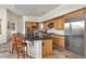 Spacious kitchen features a large island with seating, granite countertops, and stainless steel appliances at 6240 E Ironwood Dr, Scottsdale, AZ 85266