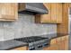 Close-up of the stainless steel gas range and hood vent in the kitchen at 6240 E Ironwood Dr, Scottsdale, AZ 85266