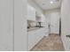 Spacious laundry room with ample cabinet space, modern washer/dryer, and tiled flooring at 6240 E Ironwood Dr, Scottsdale, AZ 85266