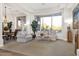 Cozy living room featuring plush seating, a large window with backyard views, and neutral décor at 6240 E Ironwood Dr, Scottsdale, AZ 85266