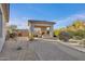 Outdoor kitchen and covered patio with grill, fireplace, and seating area in landscaped backyard at 6240 E Ironwood Dr, Scottsdale, AZ 85266