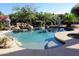 Beautiful backyard pool featuring rock features, mature landscaping, and inviting blue water at 6240 E Ironwood Dr, Scottsdale, AZ 85266