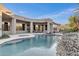 Backyard pool features a baja shelf and hot tub, set against the backdrop of the modern home at 6240 E Ironwood Dr, Scottsdale, AZ 85266