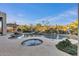 Resort-style backyard with a sparkling pool, spa, lush landscaping, and cozy lounge area at 6240 E Ironwood Dr, Scottsdale, AZ 85266