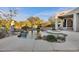 Stunning pool area features rock accents, lush greenery, and comfortable patio seating at 6240 E Ironwood Dr, Scottsdale, AZ 85266