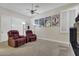 Media room with reclining chairs, carpet, and window shutters at 6240 E Ironwood Dr, Scottsdale, AZ 85266