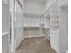 Walk-in closet featuring white built-in shelving and ample storage space at 6240 E Ironwood Dr, Scottsdale, AZ 85266
