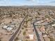 Wide aerial view of neighborhood with desert scenery, roadways, scattered homes, and mountain range backdrop at 640 E Desert Canyon Rd, Wickenburg, AZ 85390
