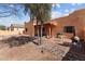 Outdoor space features a covered patio, desert landscaping, barbecue, and string lights for entertaining at 640 E Desert Canyon Rd, Wickenburg, AZ 85390