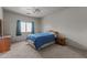 Cozy bedroom features soft carpet, a ceiling fan, and a large window at 640 E Desert Canyon Rd, Wickenburg, AZ 85390