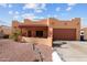 Charming single-story home features a desert landscape, attached garage, and Southwestern architectural elements at 640 E Desert Canyon Rd, Wickenburg, AZ 85390