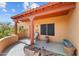 Inviting covered front porch with seating area, desert landscaping, and visible house number at 640 E Desert Canyon Rd, Wickenburg, AZ 85390