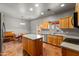 Bright kitchen with wood cabinets, center island, stainless steel appliances, and an adjacent breakfast nook with piano at 640 E Desert Canyon Rd, Wickenburg, AZ 85390