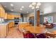 Open concept kitchen with natural wood cabinets, stainless appliances, island, and adjacent dining area at 640 E Desert Canyon Rd, Wickenburg, AZ 85390