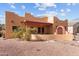 Backyard showcasing a covered patio with a tiled roof, desert landscaping, and stucco walls at 640 E Desert Canyon Rd, Wickenburg, AZ 85390