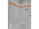 Clean and bright shower with white tiles accented by an orange-patterned border and a built-in niche at 640 E Desert Canyon Rd, Wickenburg, AZ 85390