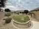 The backyard has desert landscaping with a fountain and a gazebo at 6628 W Kristal Way, Glendale, AZ 85308