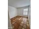 Bedroom featuring a large window with blinds, tiled floors and neutral colors at 6628 W Kristal Way, Glendale, AZ 85308