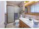 Bathroom with a glass-enclosed shower, vanity, and mirrored medicine cabinet at 6854 W Wagoner Rd, Glendale, AZ 85308