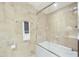 Bright bathroom featuring stone tile and a shower with a glass enclosure over a bathtub at 7161 E Rancho Vista Dr # 6002, Scottsdale, AZ 85251