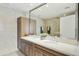 Well-lit bathroom with dual sinks, a large mirror, and elegant tile work at 7161 E Rancho Vista Dr # 6002, Scottsdale, AZ 85251