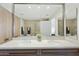 Bright bathroom featuring a double vanity, quartz countertop, modern faucets, and decorative wood accent at 7161 E Rancho Vista Dr # 6002, Scottsdale, AZ 85251