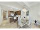 Modern dining area with a glass-top table and a view into the kitchen at 7161 E Rancho Vista Dr # 6002, Scottsdale, AZ 85251