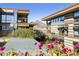 Exterior view showcases modern architecture, lush greenery, and a distant mountain view at 7161 E Rancho Vista Dr # 6002, Scottsdale, AZ 85251