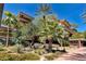 Exterior view of a condo building with mature landscaping including palm trees and flowering bushes at 7161 E Rancho Vista Dr # 6002, Scottsdale, AZ 85251