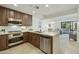Charming kitchen with stainless steel appliances and a breakfast bar, with views into the dining and living areas at 7161 E Rancho Vista Dr # 6002, Scottsdale, AZ 85251