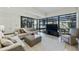 Open living room features a wall of windows, stylish furniture, and lots of natural light at 7161 E Rancho Vista Dr # 6002, Scottsdale, AZ 85251