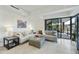 Bright living room features neutral tones, modern furniture, and sliding glass doors to a patio at 7161 E Rancho Vista Dr # 6002, Scottsdale, AZ 85251
