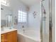 Relaxing bathroom featuring a soaking tub, glass block window, and shower at 8637 E Olla Ave, Mesa, AZ 85212