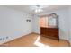 Bedroom featuring neutral walls, wood-look floors, ceiling fan, and wooden blinds at 8637 E Olla Ave, Mesa, AZ 85212