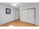 Bedroom featuring neutral walls, wood-look floors, ceiling fan, and closet at 8637 E Olla Ave, Mesa, AZ 85212