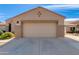Close up view of the garage with a two-car door and a well kept cement driveway at 8637 E Olla Ave, Mesa, AZ 85212