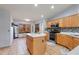 Bright kitchen with a central island, wooden cabinetry, and modern appliances for cooking at 8637 E Olla Ave, Mesa, AZ 85212