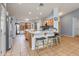 Bright eat-in kitchen featuring a bar with seating, stainless appliances, and warm wood cabinetry at 8637 E Olla Ave, Mesa, AZ 85212