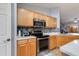 Well-equipped kitchen featuring stainless steel appliances, wooden cabinets, and a stylish backsplash at 8637 E Olla Ave, Mesa, AZ 85212