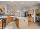 Spacious kitchen with tile flooring, a center island, stainless steel appliances, and wood cabinetry at 8637 E Olla Ave, Mesa, AZ 85212