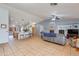 Open-concept living room and kitchen area with tile flooring, a fireplace, and plenty of natural light at 8637 E Olla Ave, Mesa, AZ 85212
