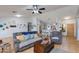 Bright, open living room featuring comfortable seating, ceiling fan, and tiled floors at 8637 E Olla Ave, Mesa, AZ 85212
