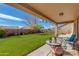 Relaxing covered patio overlooking a large, well-manicured backyard at 8637 E Olla Ave, Mesa, AZ 85212