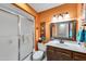 The bathroom features a vanity, sink, mirror, shower and toilet at 10825 W Caron Dr, Sun City, AZ 85351