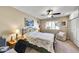 Cozy bedroom featuring a queen size bed, end tables with lamps, and a window with shutters at 10825 W Caron Dr, Sun City, AZ 85351