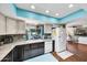 A cozy kitchen with stainless appliances, granite countertops, and a window overlooking the back yard at 10825 W Caron Dr, Sun City, AZ 85351